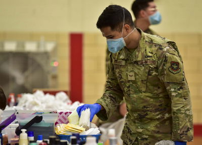 serviceman sorts through donations