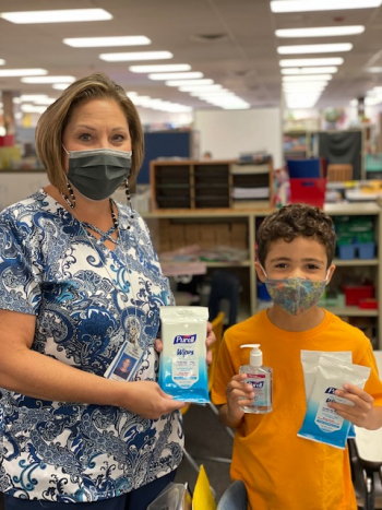 teacher and student with PPE donations