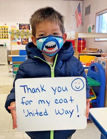 child with coat from warmest wishes coat drive